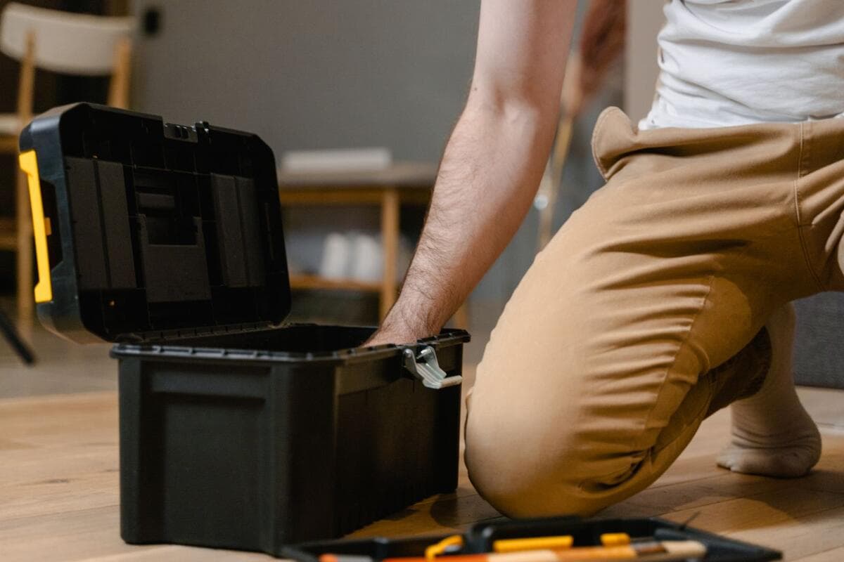 O que faz o preço subir Profissional abrindo a caixa de ferramentas para um reparo em casa